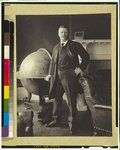 Theodore Roosevelt, full-length portrait, standing beside large globe, facing front