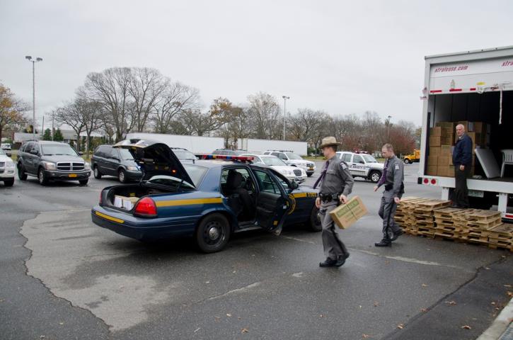 Photo: Oyster Bay, N.Y., Nov. 13, 2012 -- New York State Troopers load their squad car with food in Oyster Bay New York for delivery to home-bound survivors of Hurricane Sandy in hard-hit Long Beach New York. FEMA supplies Points of Distribution (PODs) with food, water and blankets in centralized locations for distribution to disaster survivors. Howard Greenblatt/FEMA