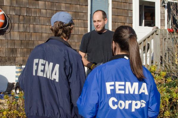 Photo: Sea Bright, N.J., Nov. 11, 2012 -- FEMA Community Relations and FEMA Corps team members speak with a disaster survivor. FEMA staff have been visiting face to face with individuals in areas impacted by Sandy in New York, New Jersey, and Connecticut.