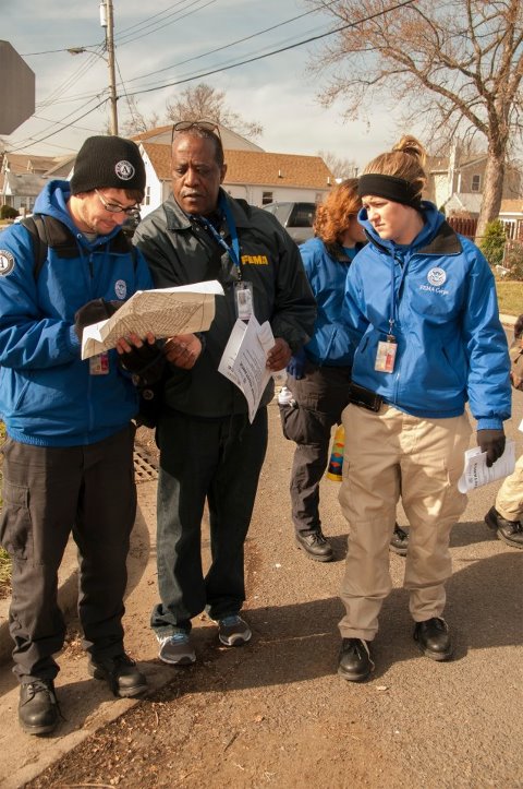 Photo: Union Beach, N.J., Nov. 15, 2012 -- Members of FEMA Corps and a FEMA Community Relations specialist review a street map while doing reaching out to residents in Union Beach, N.J., who may have been affected by Hurricane Sandy. For the latest on Sandy recovery efforts, check out www.fema.gov/sandy. Photo by Patsy Lynch/FEMA