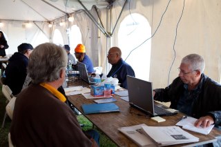 Photo: Staten Island, New York, November 10, 2012 -- FEMA personnel help survivors with the application process at a Disaster Recovery Center (DRC) in Staten Island to help those impacted by Hurricane Sandy. DRC's are used to register survivors for disaster assistance in person, and to answer questions about the procedure.    FEMA/Tim Burkitt