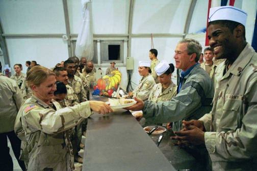 George W. Bush helps to serve Thanksgiving dinner
