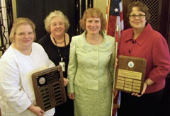 Photograph of NLS Director and Network Division Chief with Texas librarians holding award plaques.