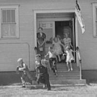 Kids run out of a schoolhouse in Grundy County, Iowa, 1939.