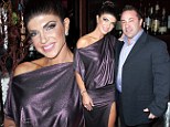 What problems? Real Housewife of New Jersey Teresa Giudice looked happy with husband Joe as they attended the Posche Fashion Show 