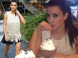 Don't spill it! Kim Kardashian tucks into a 'frozen hot chocolate' as she steps out in fringed white vest