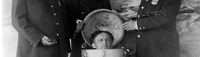 Harry Houdini performs the great milk can escape. 1908.