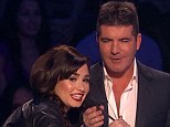 As Simon tried to introduce his first act Emblem3, Demi ripped his microphone away.