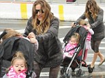 Afraid to get her feet wet! Sarah Jessica Parker jumps over water while twins balance on pram