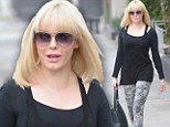 Ready for the big reveal: Rose McGowan removes her hat to reveal new long blonde bob in all its glory