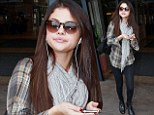 Beauty And A Beat! Selena Gomez has a spring in her step as she struts around listening to her iPod after spending the day with Justin Bieber