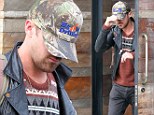 Blending in with the crowd: Ryan Gosling goes incognito as he enjoys a lunch with a friend while sporting a novelty jumper 