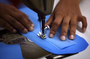 COLOMBO, SRI LANKA - DECEMBER 13:  A factory worker sews velcro onto a flack jacket to fill an order for the United Nations December 13, 2006 in Colombo, Sri Lanka. Sri Lankan body armor manufacturer Harsha International has seen orders soar in recent months as the country once again plunges into civil war between government forces and rebels from the Liberation Tamil Tigers of Eelam (LTTE). More than 3,000 people have died so far this year due to the renewed ethnic conflict.  (Photo by John Moore/Getty Images)