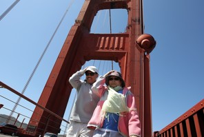 SAN FRANCISCO, CA - MAY 24:  Tourists hold onto their hats as they walk on the pedestrian walkway of the Golden Gate Bridge on May 24, 2012 in San Francisco, California. The Golden Gate Bridge, Highway and Transportation District is preparing for the 75th anniversary of the iconic Golden Gate Bridge that will be marked with a festival on May 26 - 27 that will feature music, displays of bridge artifacts and art exhibits. The 1.7 mile steel suspension bridge, one of the modern Wonders of the World, opened to traffic on May 27, 1937.  (Photo by Justin Sullivan/Getty Images)