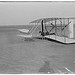 [Wilbur in prone position in damaged machine, on ground after unsuccessful trial of December 14, 1903, Kitty Hawk, North Carolina] (LOC)