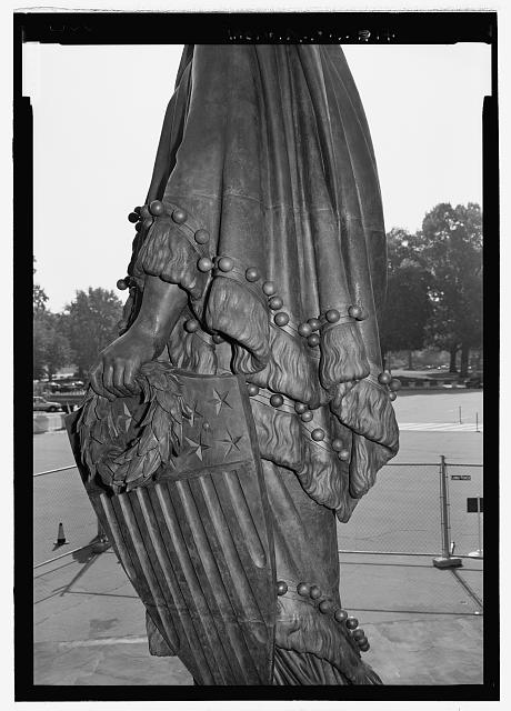 Close view looking to left side of statue showing left hand, shield, and laurel wreath - U.S. Capitol, Statue of Freedom, Intersection of North, South, & East Capitol Streets & Capitol Mall, Washington, District of Columbia, DC