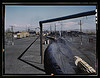 At the Santa Fe R.R. tie plant, Albuquerque, N[ew] Mex[ico]. The ties made of pine and fir, are seasoned for eight months. The steaming black ties in the center have just come from the retort where they have been impregnated with creosote for eight hours. by The Library of Congress