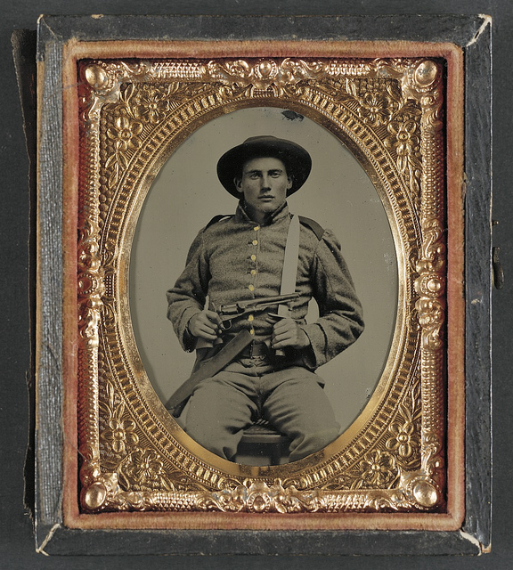 [Unidentified soldier in Confederate frock coat and slouch hat with Bowie knife and Colt Army Model 1860 revolver] (LOC)