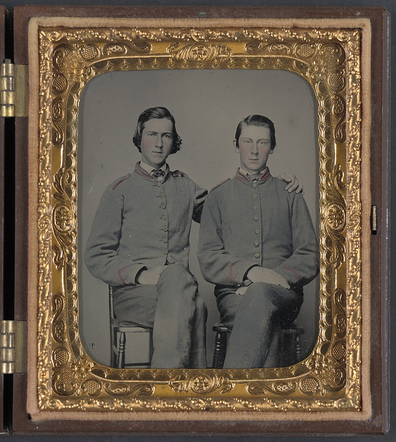 [Private William Savage Moore of Richmond "Parker" Virginia Light Artillery Battery, 1st Company Howitzers Virginia Light Artillery Battery, and I Company, 15th Virginia Infantry Regiment and his brother in early Richmond depot shell jackets] (LOC)