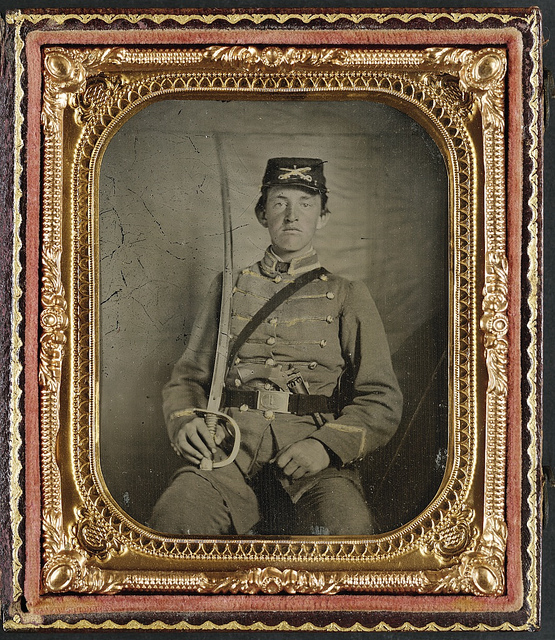 [Private David M. Thatcher of Company B, Berkeley Troop, 1st Virginia Cavalry Regiment, in uniform and Virginia sword belt plate with Adams revolver and cavalry sword] (LOC)