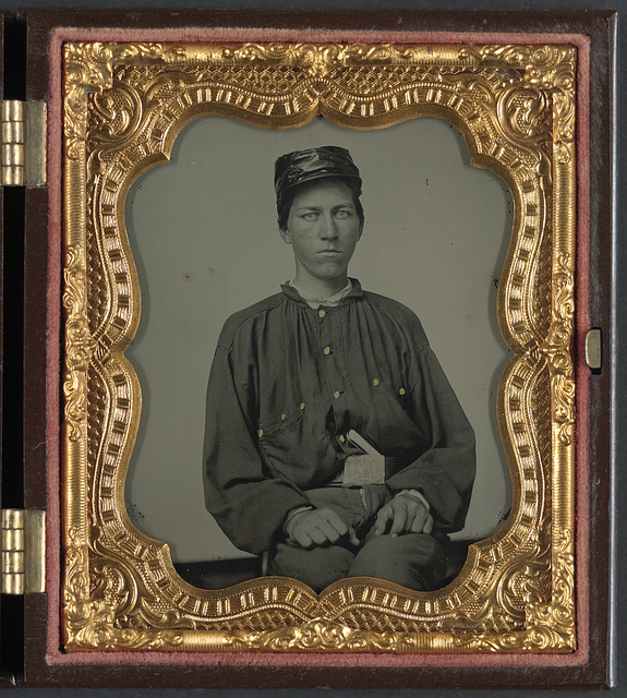 [Unidentified soldier in Confederate uniform and Louisiana state seal belt buckle and oilcloth cover on kepi] (LOC)