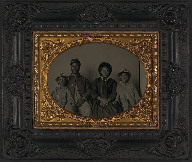 [Unidentified African American soldier in Union uniform with wife and two daughters] (LOC)