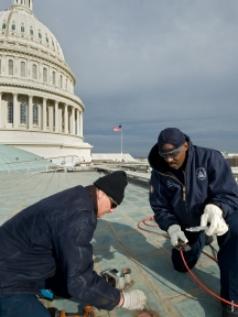 AOC staff from the Capitol Sheet Metal Shop make repairs on the roof of the Capitol.