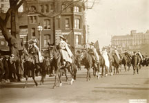 Women on horseback carrying signs