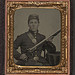 [James McGrail in Union uniform with shoulder scales and eagle breast plate sitting with a musket and bayonet in scabbard] (LOC)