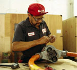 Cintron making a repair on a piece of equipment