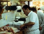 Joe Miraglia butchering a piece of veal at a work table