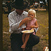 Homesteader feeding his daughter at the Pie Town, New Mexico Fair free barbeque (LOC)