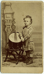 Portrait of Hine as small child standing by drum