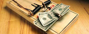 Mouse trap and cash money (© Ingram Publishing/SuperStock)