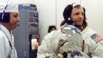 PHOTO: Apollo 11 Commander Neil Armstrong prepares to put on his helmet with the assistance of a spacesuit technician during suiting operations in the Manned Spacecraft Operations Building (MSOB) prior to the astronauts' departure to Launch Pad 39A.