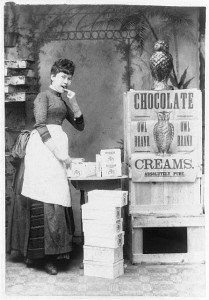  Eating chocolate. Advertisement showing a woman eating Owl Brand chocolate creams; owls are prominently featured in the advertisement (c1886)