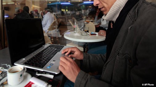 Tunisian works on his laptop in a downtown coffee shop in Tunis, Tunisia, March 16, 2011. [AP File]