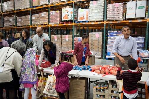 President Obama and family participate in a service project at the Capital Food Bank