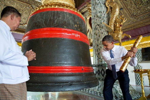 President Obama rings a large bell during a tour of the Shwedagon Pagoda