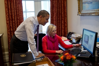 President Barack Obama and Personal Secretary Anita Decker watch a video of David Axelrod shaving off his mustache, in the Outer Oval Office, Dec. 7, 2012. (Official White House Photo by Pete Souza)