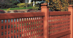 Wood fence with lattice top in corner of yard