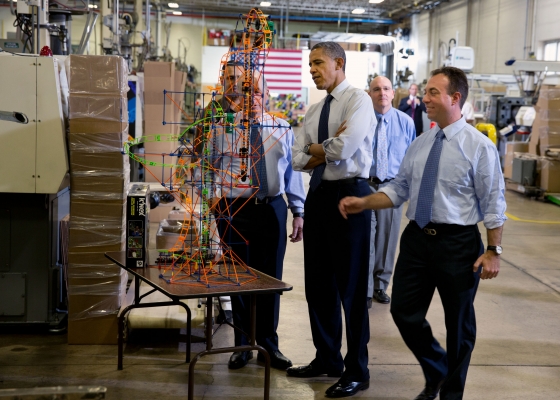 President Barack Obama examines a K'NEX rollercoaster