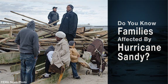 Photo of people standing around wreckage from hurricane