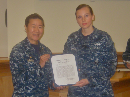 Capt. Ann K. Minami, commanding officer, Region Legal Service Office Northwest, presents the Naval Legal Service Command Sailor of the Quarter award to Legalman 1st Class (SCW) Dana E. Martinez. 