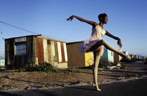 Noluyanda Mqutwana strikes a pose outside her small family house on January 30, 2000 in Khayelitsha, the biggest black township, outside Cape Town, South Africa. Noluyanda is one of about 200 unprivileged children dancing ballet in a program called Dance For All, Many children are talented and the discipline taught during the dance classes has helped many to improve their concentration in school. The township is struggling with high unemployment, crime and high levels of HIV/Aids. (Photo by Per-Anders Pettersson)