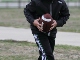 Boy running with football