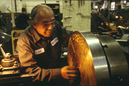 Lathe operator Humberto Reales working at Watson Machine International, a machine tool manufacturing company, Paterson, NJ, 1994. Photography by Robert McCarl.