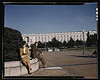 A soldier and a woman in a park, with the Old [Russell] Senate Office Building behind them, Washington, D.C. (LOC) by The Library of Congress
