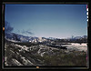 Santa Fe R.R. trains going through Cajon Pass in the San Bernardino Mountains, Cajon, Calif. On the right, streamliner "Chief" going west; in the background, on the left, a freight train with a helper engine, going east. Santa Fe trip (LOC) by The Library of Congress