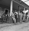 Fourth of July, near Chapel Hill, North Carolina. Rural filling stations become community centers and general loafing grounds. The men in the baseball suits are on a local team which will play a game nearby. They are called the Cedargrove Team (LOC) by The Library of Congress